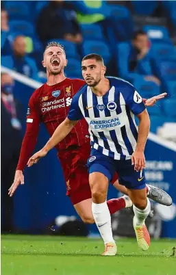  ??  ?? No joke: Liverpool’s Jordan Henderson is fouled by Brighton’s Neal Maupay during the match at the American Express Community Stadium in Brighton. — AFP