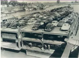  ?? | SUN- TIMES FILES ?? Cars and trucks are shipped down the Ohio River in 1947. Political parties can reconnect with Americans in the middle of the country by bringing back jobs of this sort, writes Michael Gecan.