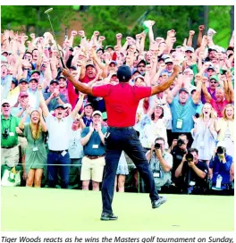  ?? AP ?? Tiger Woods reacts as he wins the Masters golf tournament on Sunday, April 14, in Augusta, Georgia.