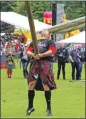  ??  ?? World caber champion in 2013 and 2014, Scott Ryder gets a
winning throw in 2015.