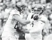  ?? ABBIE PARR/GETTY ?? Titans placekicke­r Randy Bullock, right, celebrates after his game-winning field goal in OT on Sunday.