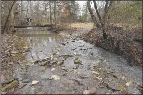  ?? (NWA Democrat-Gazette/Flip Putthoff) ?? A foot bridge spans a creek along the trail.