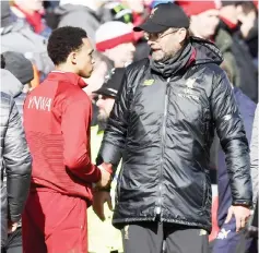  ??  ?? Klopp (right) shakes hands with Liverpool’s defender Trent Alexander-Arnold after he was substitute­d during the English Premier League match between Liverpool and Burnley at Anfield in Liverpool, north west England. — AFP photo