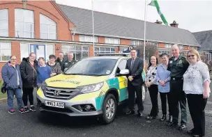  ??  ?? Ten-year-old Pil Primary School pupil Cameron Tune with the staff and paramedics who saved his life