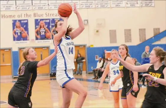  ?? Photos courtesy of Adirondack School Portraits ?? Natasha Chudy of Saratoga Springs goes up for a shot against Troy earlier this season. She is averaging 19.8 points per game this season.