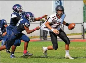  ?? SAM STEWART — DIGITAL FIRST MEDIA ?? Boyertown’s Ayden Mathias tries to get away from the Pottstown pass rush during the second quarter.