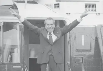  ?? BOB DAUGHERTY/AP ?? Richard Nixon salutes his staff on Aug. 9, 1974, outside the White House after resigning the presidency.