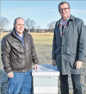  ?? SUBMITTED PHOTO ?? Kenneth Lewis, president of the P.E.I. Beekeepers Associatio­n, left, with Agricultur­e Minister Alan McIsaac and a beehive.