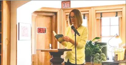  ?? Noel Ambery / For Hearst Connecticu­t Media ?? Sharon Selectwoma­n Jessica Fowler reads an excerpt from the novel “News of the World” by Paulette Jiles to an audience of 25 people at the Hotchkiss Library of Sharon’s Reading Jubilee on Saturday.