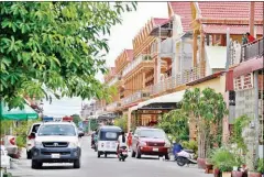  ?? POST STAFF ?? Police vehicles sit outside a house where Montagnard asylum seekers have been staying in Phnom Penh.