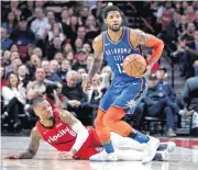  ?? [AP PHOTO] ?? Oklahoma City Thunder forward Paul George, right, dribbles away from Portland Trail Blazers guard Damian Lillard during Friday’s game in Portland, Ore.