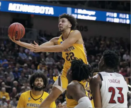  ?? NATI HARNIK - THE ASSOCIATED PRESS ?? Minnesota’s Gabe Kalscheur (22) goes for a layup as Louisville’s Steven Enoch (23) watches, during the second half of a first round men’s college basketball game in the NCAA Tournament in Des Moines, Iowa, Thursday, March 21, 2019.