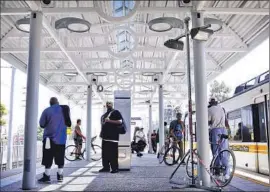  ?? Barbara Davidson Los Angeles Times ?? TRANSIT RIDERS have complained about conditions at the Rosa Parks lightrail stop in Willowbroo­k, including crime, poor lighting and crowded platforms.