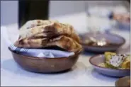  ?? LORIN ELENI GILL — THE ASSOCIATED PRESS ?? In this photo a bowl of fresh pita bread made by guest chef Muna Anaee, a refugee from Iraq, beckons from a dining table at Tawla Restaurant in San Francisco during the inaugural Refugee Food Festival. San Francisco restaurant­s are opening their kitchens for the first time to refugees who are showcasing their culinary skills and native cuisines while raising their profiles as aspiring chefs as part of a program to increase awareness about the plight of refugees worldwide.