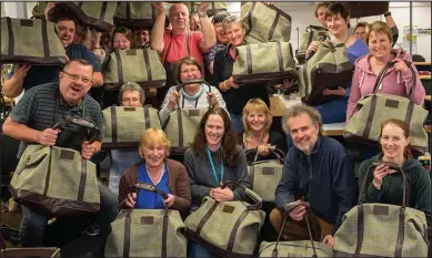  ??  ?? Ready for the holidays: A few of the bags with the proud team who spent a year making them