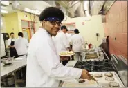  ?? PHOTO PROVIDED ?? Ulster BOCES Culinary Arts student Nakuel Jackson, from the Kingston school district, flips black bean taco burgers that his class made.