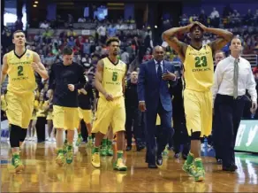  ??  ?? In this March 26 file photo, members of the Oregon team walk off the court at half time in an NCAA college basketball game against Oklahoma in the regional finals of the NCAA Tournament in Anaheim. AP PHOTO