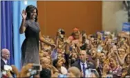  ?? THE ASSOCIATED PRESS ?? First lady Michelle Obama waves to supporters as she arrives on stage prior to speaking during a campaign rally for Democratic presidenti­al candidate Hillary Clinton on Thursday in Phoenix.