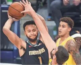  ??  ?? Memphis Grizzlies forward Kyle Anderson looks to pass the ball as Los Angeles Lakers center Marc Gasol defends during their game at the Fedexforum on Tuesday.