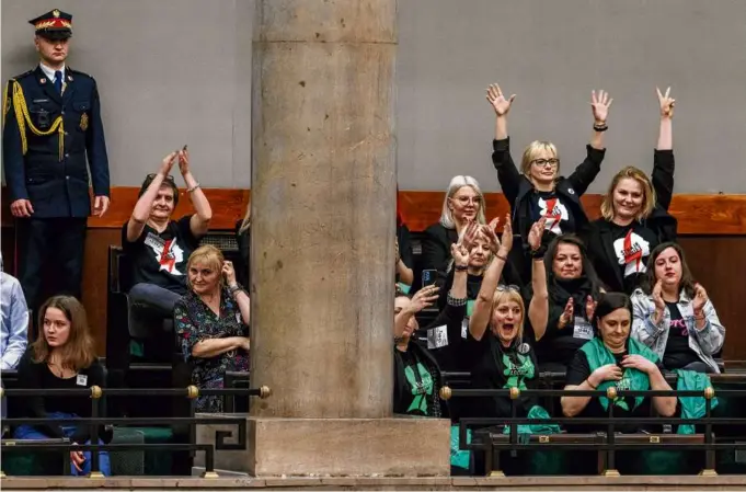  ?? WOJTEK RADWANSKI/AFP VIA GETTY IMAGES ?? Abortion-rights activists reacted after the Polish parliament voted to continue work on proposals to liberalize abortion laws on Friday.