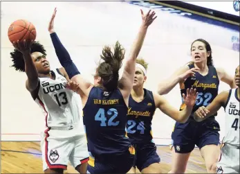  ?? David Butler II / USA Today ?? UConn’s Christyn Williams (13) shoots against Marquette’s Lauren Van Kleunen (42) in the second quarter at Gampel Pavilion.