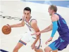  ?? SARAH PHIPPS/THE OKLAHOMAN ?? Oklahoma City's Aleksej Pokusevski looks to drive past Charlotte's Cody Zeller during the Hornets' 113-102 victory on April 7 at Chesapeake Energy Arena.