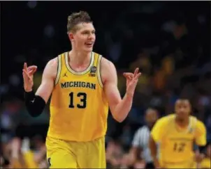  ?? CHARLIE NEIBERGALL — THE ASSOCIATED PRESS ?? Michigan’s Moritz Wagner (13) reacts after scoring a 3-point shot against Loyola-Chicago during the second half on Saturday in San Antonio.
