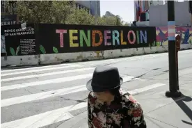  ?? Photograph: Jeff Chiu/AP ?? A person walks through San Francisco’s Tenderloin district. The city saw a spike in drug overdose deaths, which may have been linked to the closure of a drug outreach center.