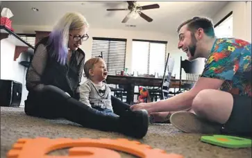  ?? Christina House Los Angeles Times ?? HOME BUYERS Heather Mathiesen and James Cunningham play with their year-old son, Hugo, in their $350,000 house in Lancaster. The couple had to tap their 401(k) retirement plans to afford the down payment.