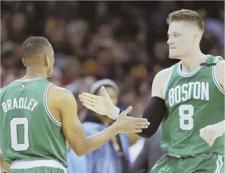  ?? AP PHOTO ?? CALM, COLLECTED: Avery Bradley (left) celebrates with Jonas Jerebko after hitting the winning shot in the final second of the Celtics’ 111-108 victory against the Cavaliers in Game 3 last night in Cleveland.