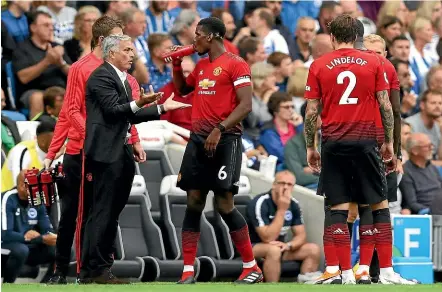  ?? GETTY IMAGES ?? Manchester United boss Jose Mourinho speaks with Paul Pogba to try to get something going against Brighton.