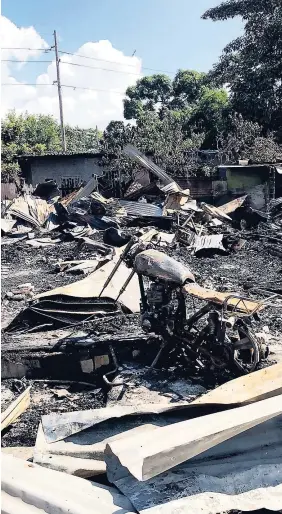  ?? ANDRE WILLIAMS PHOTOS ?? More than 30 persons are now homeless because of a massive blaze in the Bell Rock community, off Olympic Way, St Andrew, on Wednesday.