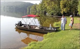  ?? The Sentinel-Record/Richard Rasmussen ?? PARK OF THE YEAR: Two campers prepare to boat out onto Lake Catherine in late August in this file photo. Lake Catherine State Park received “Park of the Year” for Arkansas State Parks Region 1 for its commitment to excellence.