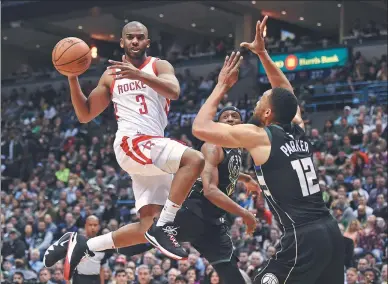  ?? BENNY SIEU / USA TODAY SPORTS ?? Houston Rockets guard Chris Paul dishes off a pass above Milwaukee Bucks forward Jabari Parker in the third quarter of Wednesday’s game at BMO Harris Bradley Center in Milwaukee. The Rockets defeated the Bucks 110-99 to record their 17th straight...