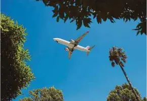  ?? BLOOMBERG PIC ?? An aircraft preparing to land at the Sydney Airport in Sydney. The Melbourne-Sydney route is among the 10 busiest air routes in the world last year.