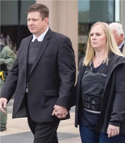 ?? SUN-TIMES FILES ?? Chicago Police Officer Jason Van Dyke and his wife, Tiffany, walk out of the Leighton Criminal Court Building last month.