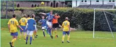  ?? 01_B28footy05 ?? Brodick players and the opposition goalkeeper challenge for the ball.