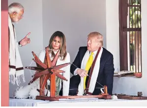  ?? PHOTO:PTI ?? US President Donald Trump and first lady Melania with Prime Minister Narendra Modi, during a tour of Gandhi Ashram in Ahmedabad, on Monday