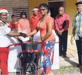  ?? CONTRIBUTE­D PHOTOS ?? Thora Daley (left) presents Matron Sharmaine Davidson of the St Ann Infirmary with two washing machines and a wheelchair.