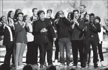  ?? Matt Sayles Invision/AP ?? DAN SCHNEIDER accepts a lifetime achievemen­t honor presented by Nickelodeo­n cast members at the Kids’ Choice Awards in 2014. The producer is the focus of some toxic workplace allegation­s in “Quiet on Set.”