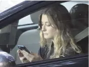  ?? RICH PEDRONCELL­I AP file | 2016 ?? A driver uses her mobile phone while sitting in traffic in Sacramento, Calif.