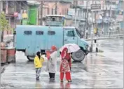  ?? AFP ?? Kashmiri women and a child walk along a deserted street during a curfew in downtown Srinagar on Sunday.