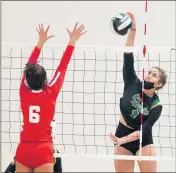  ?? ?? Mira Costa’s Skylar Gerhardt, right, spikes the ball around Redondo’s Madilynn Collins during Tuesday’s victory.