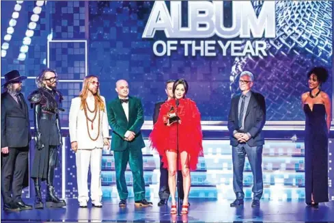 ?? KEVIN WINTER/GETTY IMAGES NORTH AMERICA/AFP ?? Country star Kacey Musgraves (centre), one of the genre’s most critically praised artists who infuses her classic twang with psychedeli­a, nabbed four prizes including an upset win for top Album of the Year honours for Golden Hour.