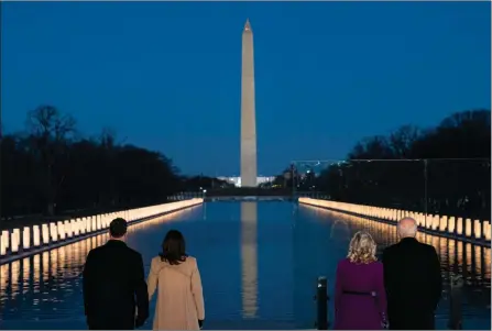  ?? The Associated Press ?? President-elect Joe Biden and his wife, Jill Biden, join Vice President-elect Kamala Harris and her husband, Doug Emhoff, during a COVID-19 memorial event at the Lincoln Memorial Reflecting Pool, Tuesday, in Washington.