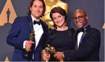  ??  ?? (From left) Jeremy Kleiner, Adele Romanski and Barry Jenkins pose in the press room with the Oscar for Best Picture.