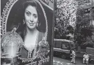  ?? THE ASSOCIATED PRESS ?? Indian policemen stand guard near a picture of Indian actress Sridevi displayed outside her residence in Mumbai, India, on Tuesday.