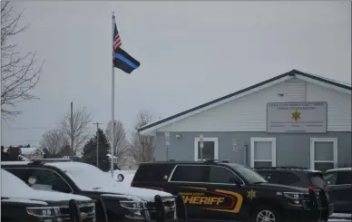  ?? JOSHUA WAGNER — MEDIA NEWSGROUP ?? On the flag pole in front of the Madison County Jail is a different, older version of the Thin Blue Line Flag, according to county sheriff Todd Hood.