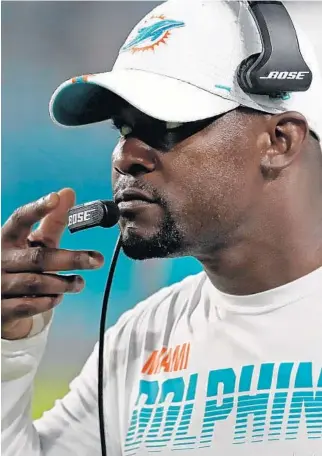  ?? JOHN MCCALL/SUN SENTINEL ?? Coach Brian Flores leads the Dolphins to a 34-27 win over the Falcons at Hard Rock Stadium on Thursday.