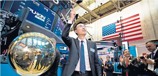  ??  ?? Yunlong Sha, the founder of Puxin, opens trading in the Beijing-based education company. While Us-chinese worries left the Dow off 1pc in late trade, Puxin shares rose 18pc on their New York debut